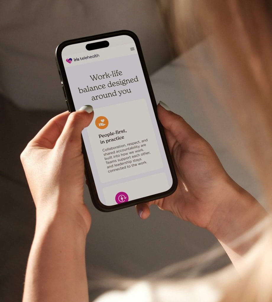 Person holding a smartphone showing the Iris Telehealth app with the headline 'Work-life balance designed around you'.